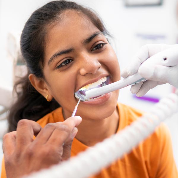 mouth being examined with small camera