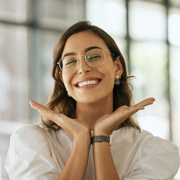 smiling person framing own face