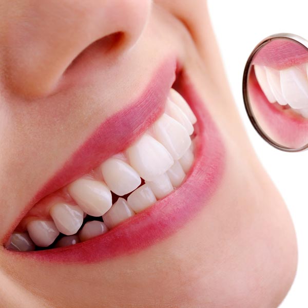 smiling teeth examination with small mirror